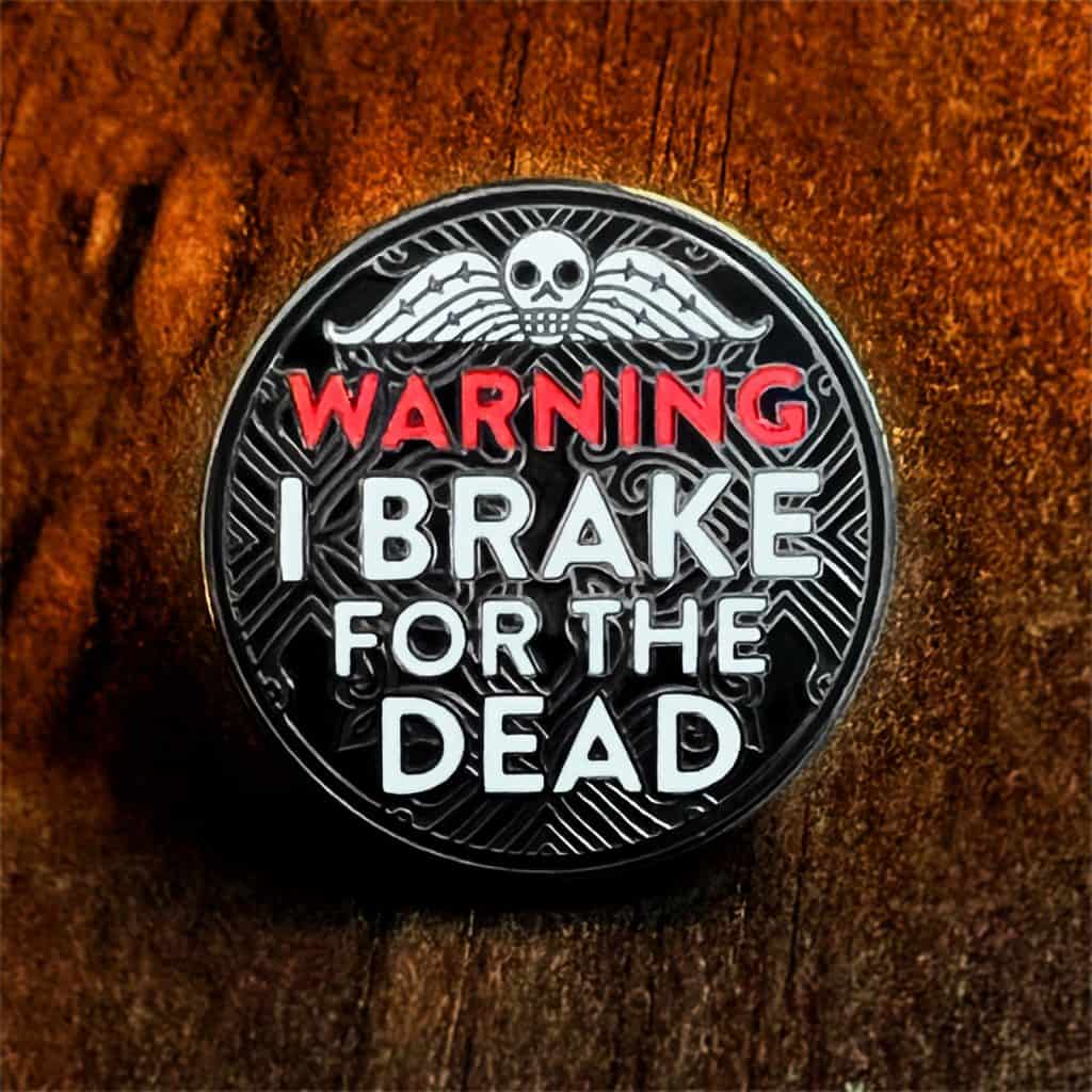 The "Warning: I Brake for the Dead" Pin from Haunts & Hollows